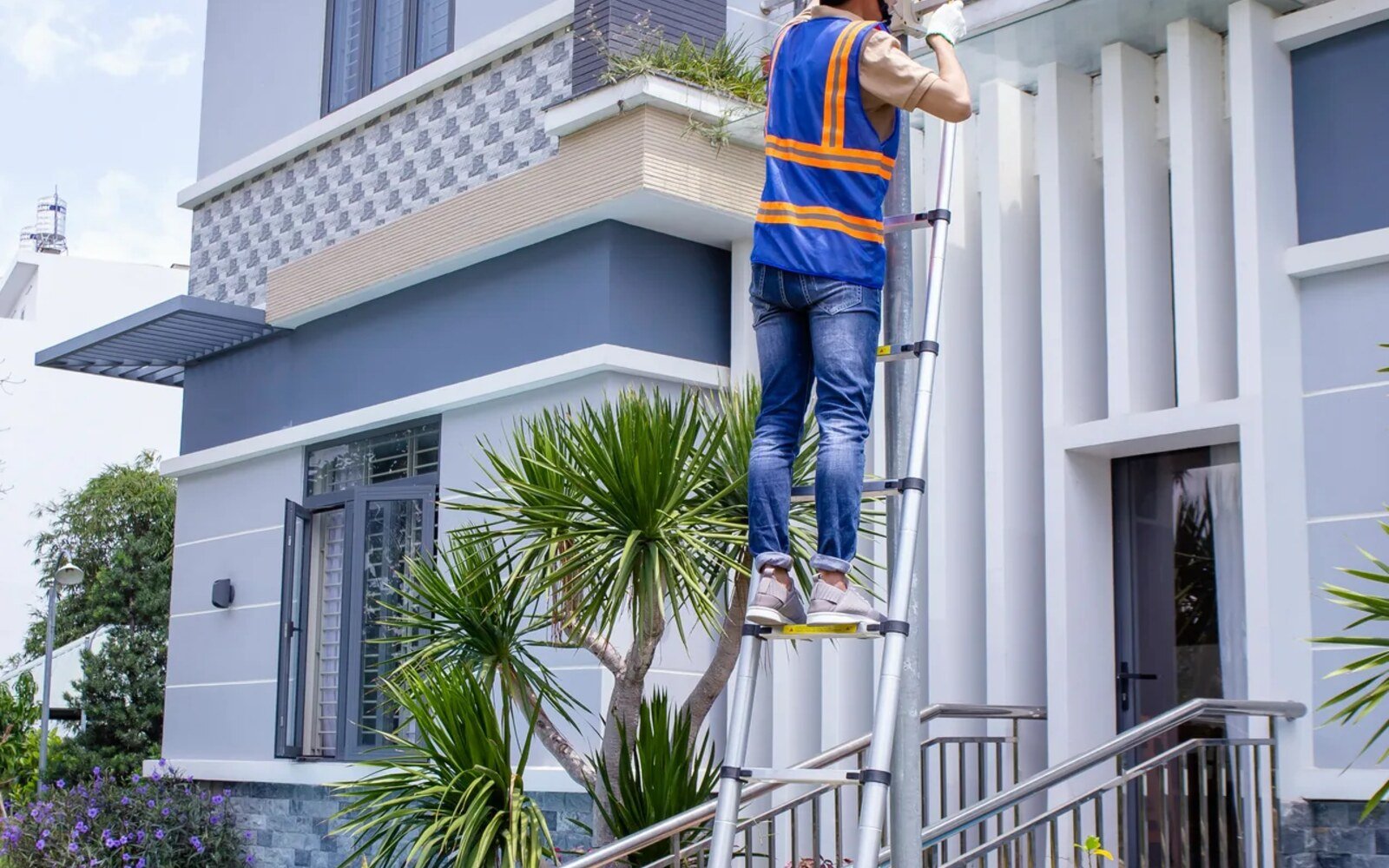 Property maintenance technician working on a Dubai villa exterior